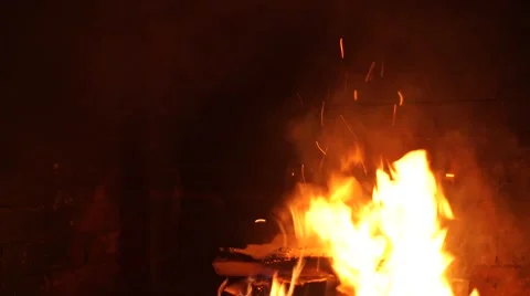 A bright fire in the fireplace. A warm light. A fireplace in a dark room. Beauti Stock Footage 64816019
