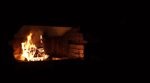 A bright fire in the fireplace. A warm light. A fireplace in a dark room. Beauti Stock Footage 64816060