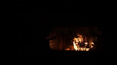 A bright fire in the fireplace. A warm light. A fireplace in a dark room. Beauti Stock Footage 64816061