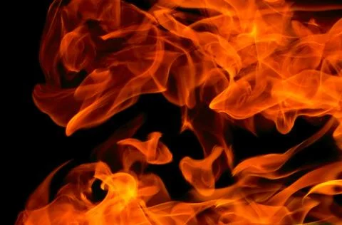 Bright fire flame on a black background Stock Photos