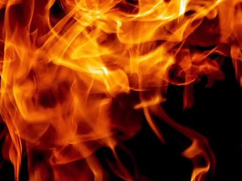 Bright fire flame on a black background Stock Photos