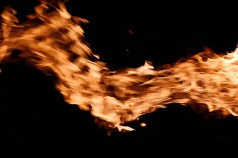 Bright fire flames burning in the dark sky. Isolated on black background Stock Photos