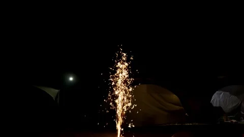 Bright  firework erupts in the center of a dark night Stock Footage 328617549
