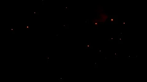 A bright firework explodes in the night sky Video stock 321538063