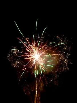 Bright firework explosion in the dark night sky Stock Photos