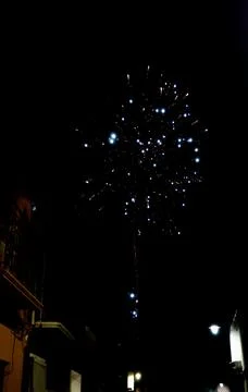 Bright firework explosion in night sky with golden light trails Stock Photos