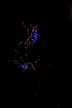 Bright firework explosion in night sky with golden light trails Stock Photos