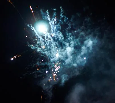 Bright firework rocket covered by smoke in the night sky background Foto stock