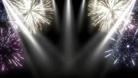 Bright Fireworks Exploding Over A Dark Stage With Vertical Spotlight Beams In A 스톡 동영상 338438534