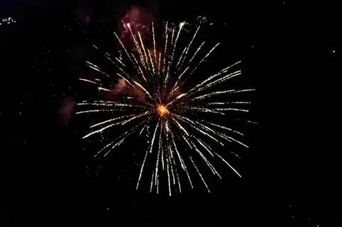 Bright fireworks explosion in the dark night sky Stock Photos