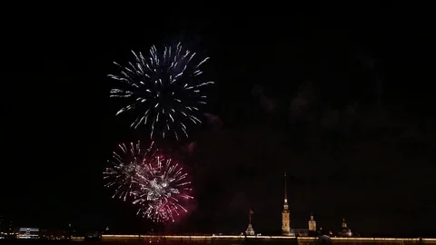 Bright fireworks explosions and sparks at night sky over Peter and Paul fortress Stock Footage