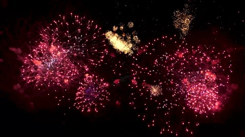 Bright fireworks sparkle against a black sky, burgundy and gold  스톡 동영상 338410662