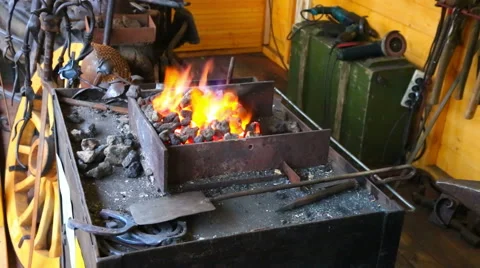Bright flame and tools in a forge Stock Footage 54622853
