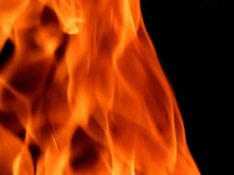 Bright flame of fire on a black background Stock Photos