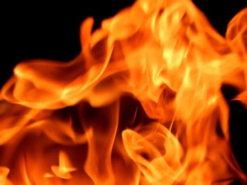 Bright flame of fire on a black background Stock Photos
