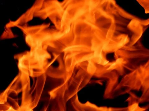 Bright flame of fire on a black background Stock Photos