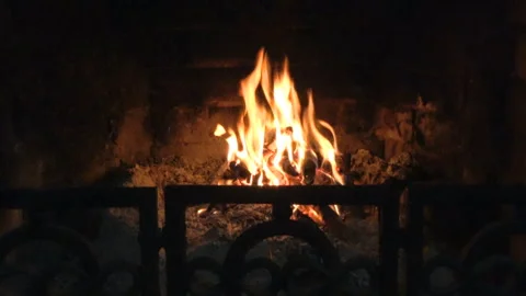 Bright flame of fire burns in a fireplace in the old house in winter evening Stock Footage 306363844