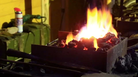 Bright flame over coals in a forge Video stock 57227273
