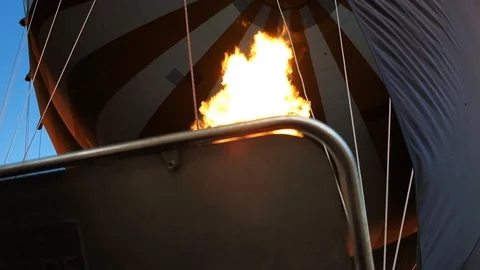 A bright flame of yellow color is directed into the dome of the balloon. Stock Footage 111366419