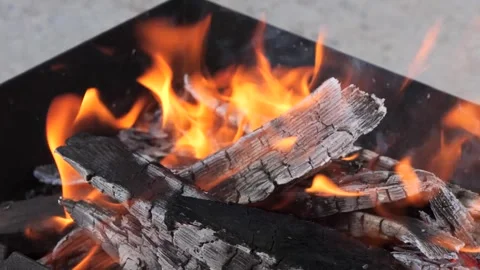 Bright flames burst from a grill in the backyard. Stock-Footage 285263283