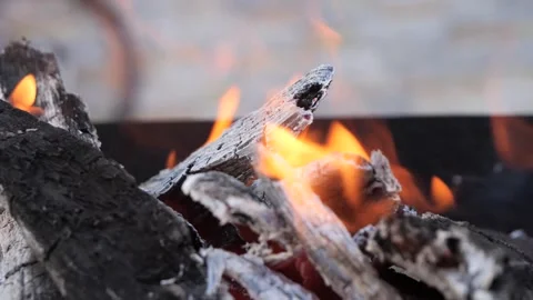 Bright flames burst from a grill in the backyard. Stockbeeldmateriaal 286373617