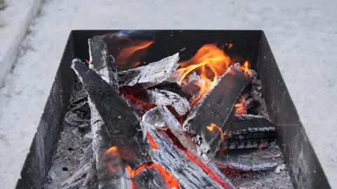 Bright flames burst from a grill in the backyard. Stock-Footage 288897052