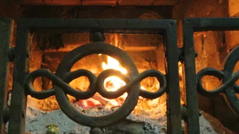 Bright flames of fire burn in a fireplace with a beautiful metal grate Stock Footage 306363931