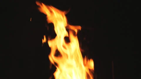 Bright flames rises from burning slices wood and charcoal in mangal at night Stock Footage 194528456