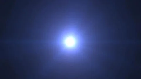 Bright Flare of Light in Dark Sky with Blue Hue and Lens Effect Stock Photos