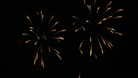 Bright flashes of festive fireworks colors in the night sky. Stock Footage 201015480