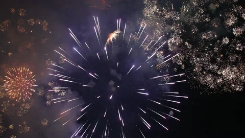 Bright flashes of festive fireworks in the night black sky. Video stock 193602404