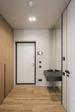 Bright flat corridor with white front door Stock Photos