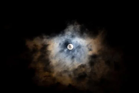 Bright full moon on cloudy scene of night sky. Stock Photos