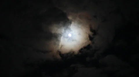 Bright full moon in darkness with clouds passing in front Stock Footage 31399305