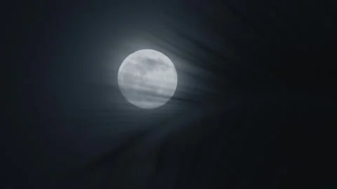 Bright full moon illuminating night sky, partially shrouded by wispy clouds Stock Footage 312746557