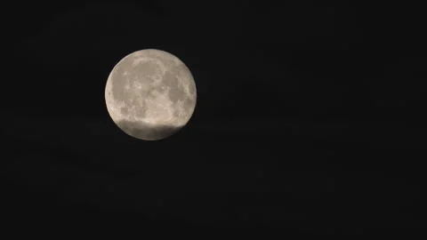 Bright Full Moon Partially Veiled by Soft, Transparent Clouds. Stock Footage 314615936