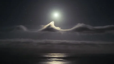 Bright full moon rising over the ocean at night Stock Footage 333150598