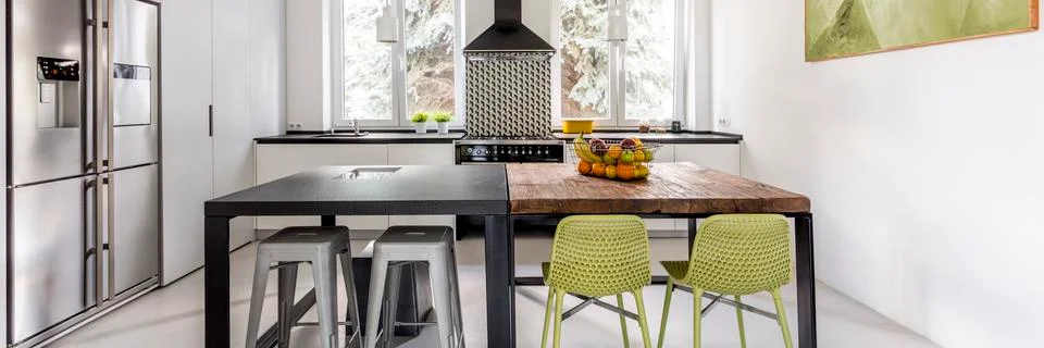 Bright functional kitchen with two tables Foto stock