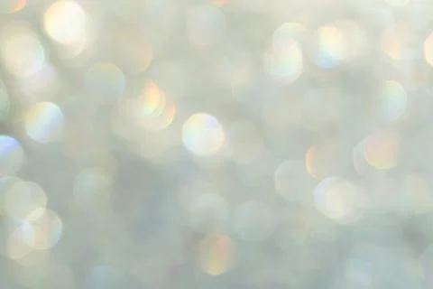 Bright glitter background: bokeh effect from many colored lights on frozen gl Stock Photos