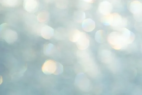 Bright glitter background: bokeh effect from many colored lights on frozen gl Stock Photos