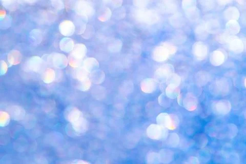 Bright glitter background: bokeh effect from many colored lights on frozen gl Stock Photos
