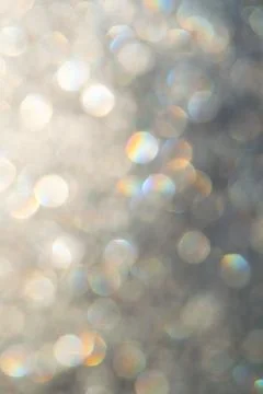 Bright glitter background: bokeh effect from many colored lights on frozen gl Stock Photos