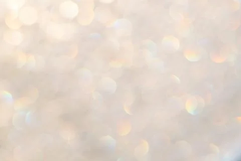 Bright glitter background: bokeh effect from many colored lights on frozen gl Stock Photos