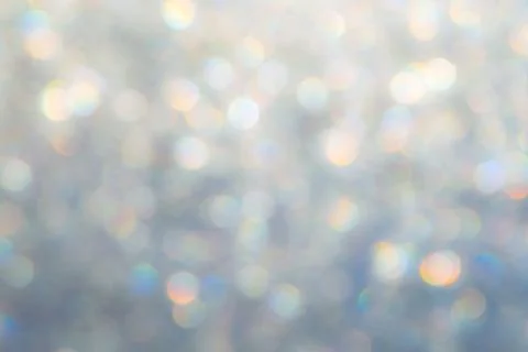 Bright glitter background: bokeh effect from many colored lights on frozen gl Stock Photos
