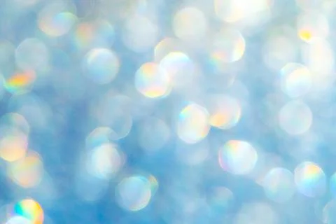 Bright glitter background: bokeh effect from many colored lights on frozen gl Stock Photos