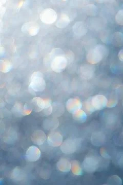 Bright glitter background: bokeh effect from many colored lights on frozen gl Stock Photos
