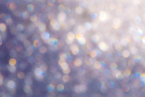 Bright glitter background: bokeh effect from many colored lights on frozen gl Stock Photos