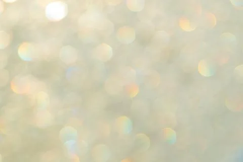 Bright glitter background: bokeh effect from many colored lights on frozen gl Stock Photos