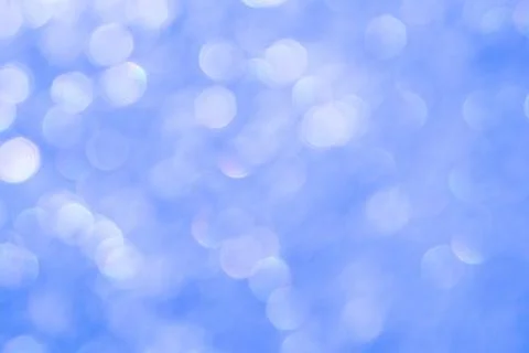 Bright glitter background: bokeh effect from many colored lights on frozen gl Stock Photos