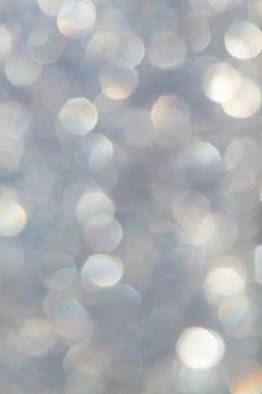 Bright glitter background: bokeh effect from many colored lights on frozen gl Stock Photos